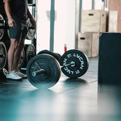 Close-up of athletic shoes on a gym floor.