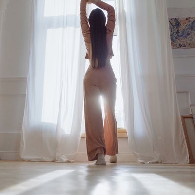 Silhouette in a dynamic pose against a bright window.