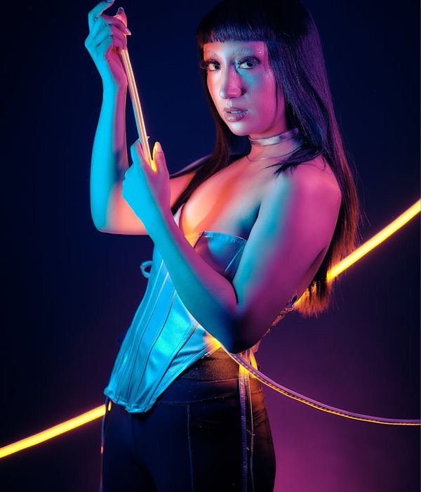 Woman in a dynamic cardio pose with yellow light accents.